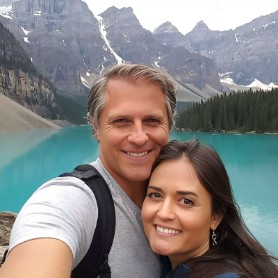 Scott Sveslosky with his wife Danica McKellar taking a selfie on a blue lake.